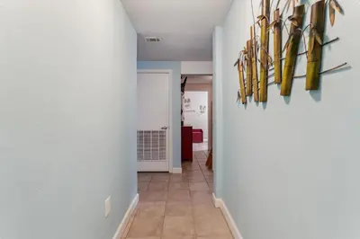 a hallway with skis hanging on a wall at Peak-Shore Overlook - Sleeps 8 in Panama City Beach