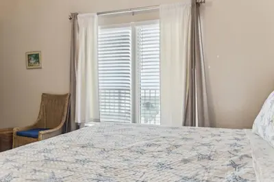 a bedroom with a large bed and a window at Peak-Shore Overlook - Sleeps 8 in Panama City Beach