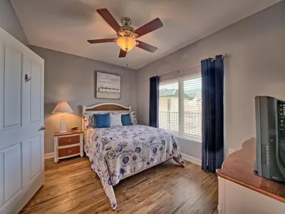 a bedroom with a bed and a ceiling fan at Shores of Panama 1307, Two Masters! in Panama City Beach