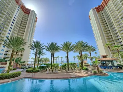 a pool in the middle of two buildings with palm trees at Shores of Panama 1307, Two Masters! in Panama City Beach