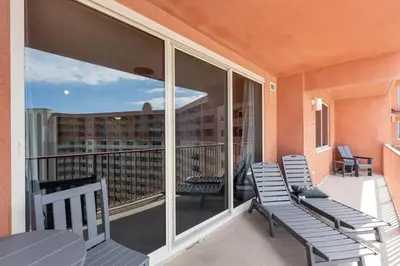 a balcony with two chairs and a view of a building at Shores of Panama 2115, 2BR 2 BA, sleeps 6 in Panama City Beach
