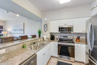 a kitchen with white cabinets and stainless steel appliances at Shores of Panama 2115, 2BR 2 BA, sleeps 6 in Panama City Beach