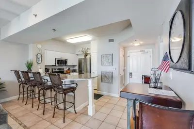 a kitchen and living room with a bar and chairs at Shores of Panama 2115, 2BR 2 BA, sleeps 6 in Panama City Beach