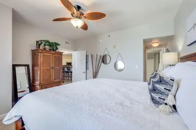 a bedroom with a white bed and a ceiling fan at Shores of Panama 2115, 2BR 2 BA, sleeps 6 in Panama City Beach