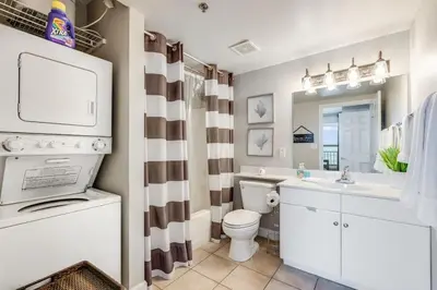 a bathroom with a white toilet and a sink at Shores of Panama 2115, 2BR 2 BA, sleeps 6 in Panama City Beach