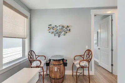 a room with a table and two chairs and a barrel at 221 Sands Street - 4 BR with Private pool in Panama City Beach