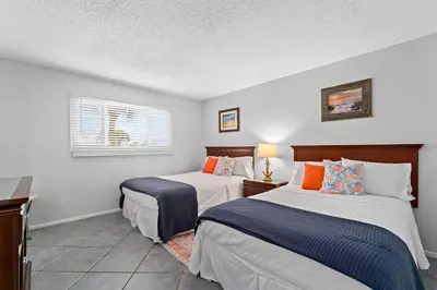 a bedroom with two beds and a window at Regency Towers 207 - Sleeps 8 -East-Gulf Overview in Panama City Beach
