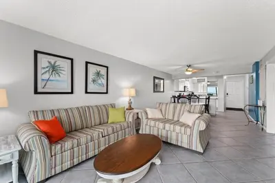 a living room with two couches and a table at Regency Towers 207 - Sleeps 8 -East-Gulf Overview in Panama City Beach