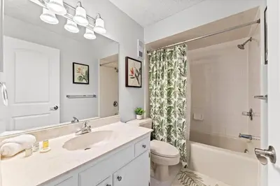 a bathroom with a sink and a toilet and a tub at Regency Towers 207 - Sleeps 8 -East-Gulf Overview in Panama City Beach