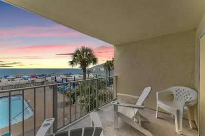 a balcony with chairs and a view of the beach at Regency Towers 207 - Sleeps 8 -East-Gulf Overview in Panama City Beach