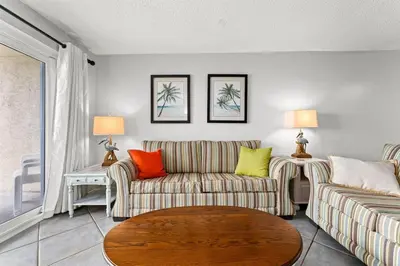 a living room with two couches and a table at Regency Towers 207 - Sleeps 8 -East-Gulf Overview in Panama City Beach