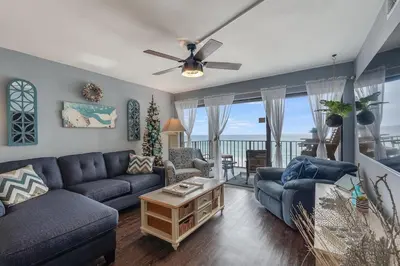 a living room with a couch and a table at Moondrifter 804 - Sleeps 6 - 2 BR 2 BA with bunks in Panama City Beach