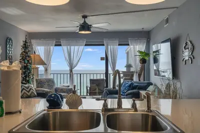 a kitchen with a sink and a view of the ocean at Moondrifter 804 - Sleeps 6 - 2 BR 2 BA with bunks in Panama City Beach