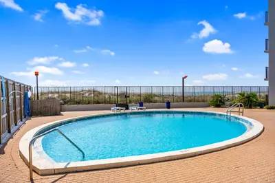 a large swimming pool in the middle of a building at Moondrifter 804 - Sleeps 6 - 2 BR 2 BA with bunks in Panama City Beach