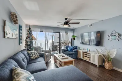 a living room with a blue couch and chairs at Moondrifter 804 - Sleeps 6 - 2 BR 2 BA with bunks in Panama City Beach