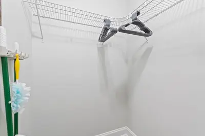 a shopping cart hanging on a white wall at Top of the Gulf 120 - Shore-side Bungalow Sleeps 4 in Panama City Beach