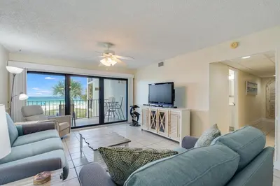 a living room with a couch and a tv at Moondrifter 305 - 2 BR - Oceanfront condo Sleeps 6 in Panama City Beach