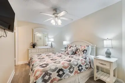 a bedroom with a bed and a ceiling fan at Moondrifter 305 - 2 BR - Oceanfront condo Sleeps 6 in Panama City Beach