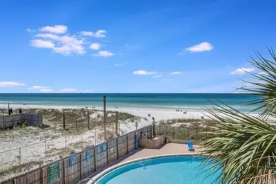 a swimming pool in front of the beach at Moondrifter 305 - 2 BR - Oceanfront condo Sleeps 6 in Panama City Beach