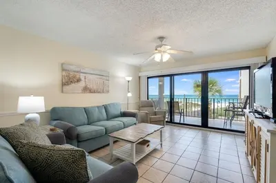 a living room with a couch and a table at Moondrifter 305 - 2 BR - Oceanfront condo Sleeps 6 in Panama City Beach