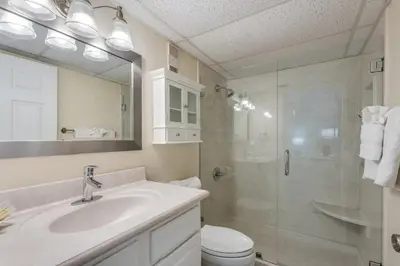a bathroom with a toilet and a sink and a shower at Moondrifter 305 - 2 BR - Oceanfront condo Sleeps 6 in Panama City Beach