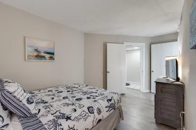 a bedroom with a bed and a tv on a dresser at Moondrifter 604 - Emerald Gulf Retreat - Sleeps 6 in Panama City Beach