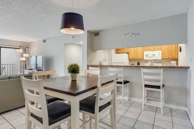 a kitchen and dining room with a table and chairs at Moondrifter 604 - Emerald Gulf Retreat - Sleeps 6 in Panama City Beach