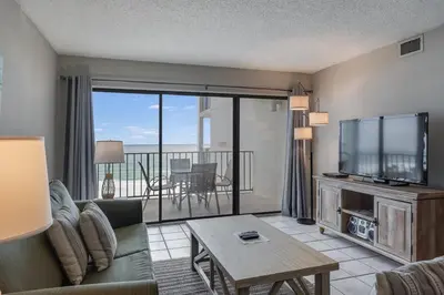 a living room with a couch and a flat screen tv at Moondrifter 604 - Emerald Gulf Retreat - Sleeps 6 in Panama City Beach