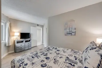 a bedroom with a bed and a television in it at Moondrifter 604 - Emerald Gulf Retreat - Sleeps 6 in Panama City Beach