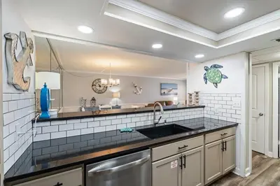 a kitchen with a sink and a counter top at Moondrifter 205 - Sand-Side Oasis - Sleeps 6 in Panama City Beach