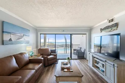 a living room with a couch and a flat screen tv at Moondrifter 205 - Sand-Side Oasis - Sleeps 6 in Panama City Beach