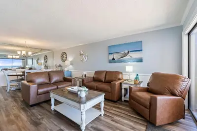 a living room with two couches and a table at Moondrifter 205 - Sand-Side Oasis - Sleeps 6 in Panama City Beach