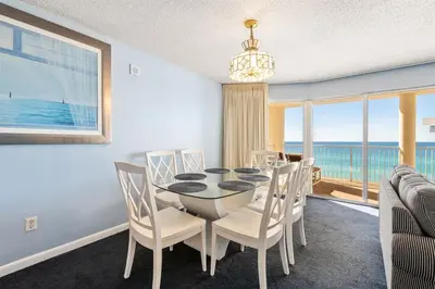 a dining room with a table and chairs and the ocean at Long Beach Tower 2 #703 Beachfront 2 BR 2 BA in Panama City Beach