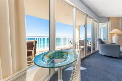 a room with a glass table with a view of the ocean at Long Beach Tower 2 #703 Beachfront 2 BR 2 BA in Panama City Beach