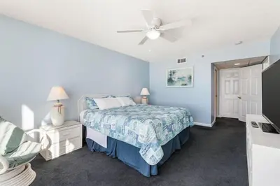 a bedroom with a bed and a ceiling fan at Long Beach Tower 2 #703 Beachfront 2 BR 2 BA in Panama City Beach