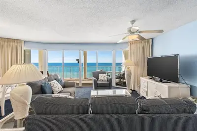 a living room with a couch and a flat screen tv at Long Beach Tower 2 #703 Beachfront 2 BR 2 BA in Panama City Beach