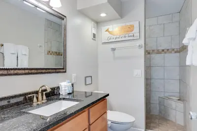 a bathroom with a sink and a toilet and a shower at Sand-Crest Overlook - Moondrifter 201 in Panama City Beach