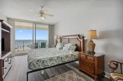 a bedroom with a bed with a view of the ocean at Majestic Condo- Tower 2 #206 3 BR 3 BA Low floor! in Panama City Beach
