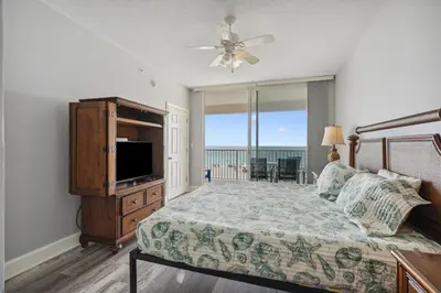 a bedroom with a bed and a flat screen tv at Majestic Condo- Tower 2 #206 3 BR 3 BA Low floor! in Panama City Beach