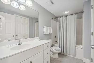 a white bathroom with a sink and a toilet at Majestic Condo- Tower 2 #206 3 BR 3 BA Low floor! in Panama City Beach