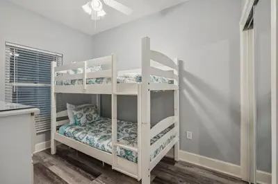 a couple of bunk beds in a room at Majestic Condo- Tower 2 #206 3 BR 3 BA Low floor! in Panama City Beach