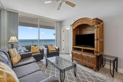 a living room with a couch and a flat screen tv at Majestic Condo- Tower 2 #206 3 BR 3 BA Low floor! in Panama City Beach