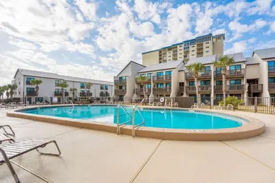 a swimming pool in front of a hotel at Largo Mar 143 - Sand-Side Paradise Townhome in Panama City Beach