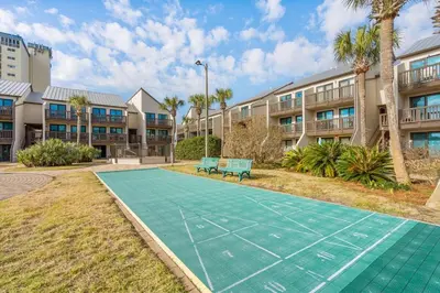 a tennis court in front of some apartment buildings at Largo Mar 143 - Sand-Side Paradise Townhome in Panama City Beach
