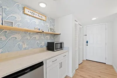 a kitchen with a counter top with a microwave at Commodore 606 3 BR 3 BA Sleeps 12 in Panama City Beach