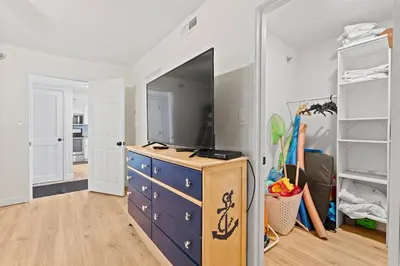 a room with a blue dresser and a mirror at Commodore 606 3 BR 3 BA Sleeps 12 in Panama City Beach