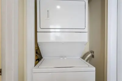 a white refrigerator freezer sitting inside of a door at Edgewater Windward 104 - 1 BR beachfront sleeps 4 in Panama City Beach