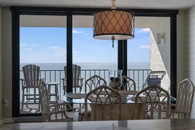 a dining room with a view of the ocean at Edgewater T3 #802 - 2 BR 2 BA Amazing views in Panama City Beach