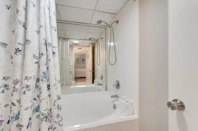 a bathroom with a tub and a shower curtain at Edgewater T3 #802 - 2 BR 2 BA Amazing views in Panama City Beach