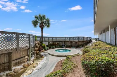 a backyard with a swimming pool and a fence at Edgewater T3 #802 - 2 BR 2 BA Amazing views in Panama City Beach